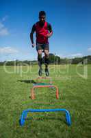 Soccer player practicing on obstacle