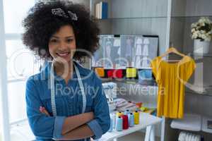 Portrait of female designer standing with arms crossed