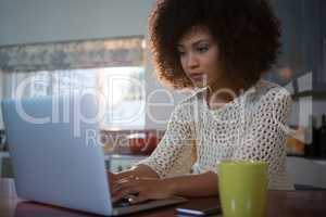 Beautiful woman using laptop at table