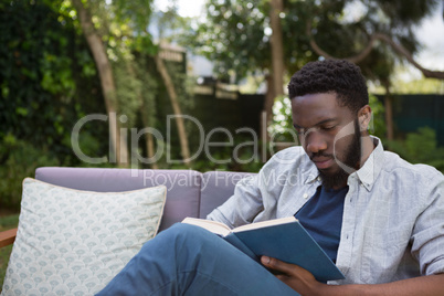 Man reading a novel in garden