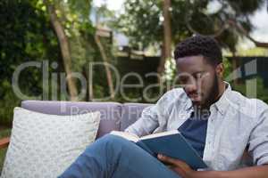 Man reading a novel in garden