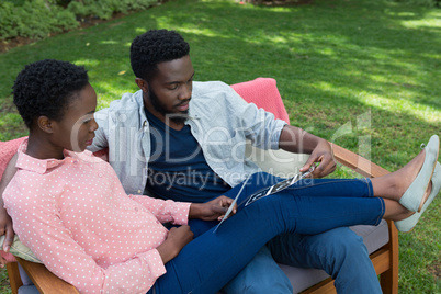 Couple looking at looking at sonography in park