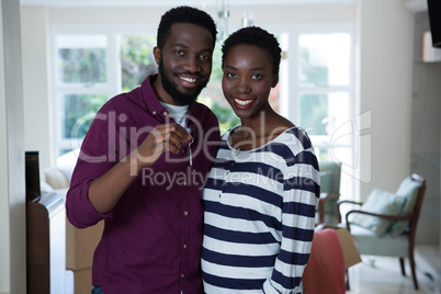 Happy couple holding a key of new house