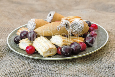 Biscuits and cherries on the plate. The view from the top