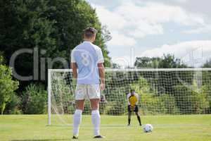 Soccer player is ready to kick ball from penalty spot