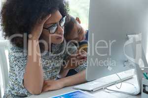 Mother with his son looking at computer