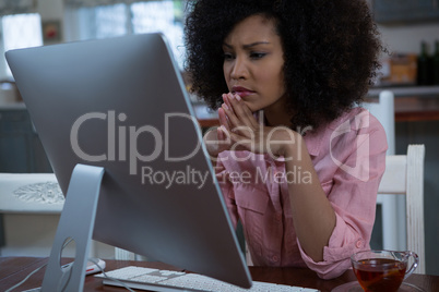 Woman using computer at home