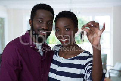 Happy couple holding a key of new house