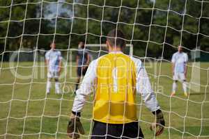 Soccer players ready to kick ball from penalty spot