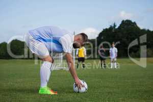 Football player ready to kick the soccer ball