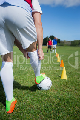 Soccer player practicing in the ground