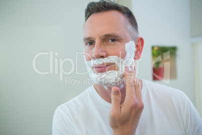 Man applying shaving foam on his face