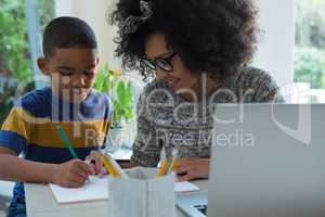 Mother helping his son in doing homework 4k