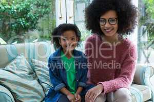 Mother and daughter sitting together in living room