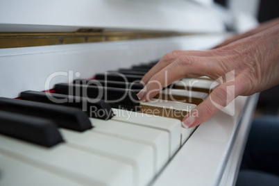 Close-up of woman playing piano