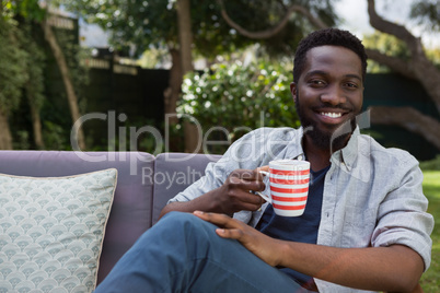 Man having black coffee in garden