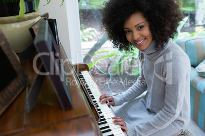 Portrait of beautiful woman playing piano