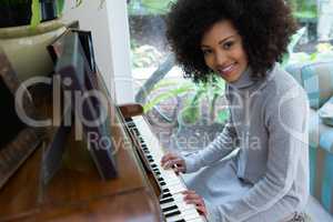 Portrait of beautiful woman playing piano