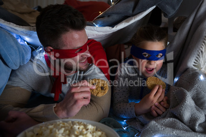 Father and son pretending to be superhero