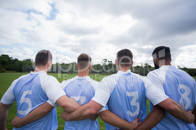 Football player standing together with arm around