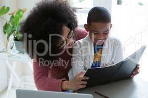 Mother helping her son in his studies