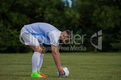 Football player ready to kick the soccer ball