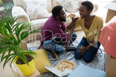 Couple having pizza in new house