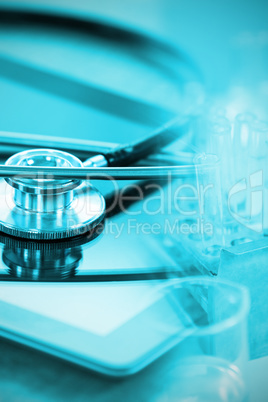 Composite image of stethoscope on digital tablet