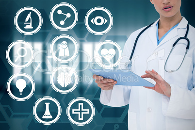 Composite image of focused doctor using her tablet pc