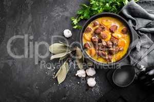 Meat stew, goulash in a cast iron pot, top view
