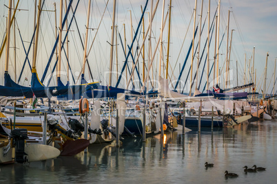 Yacht wharf on lake in summer morning.