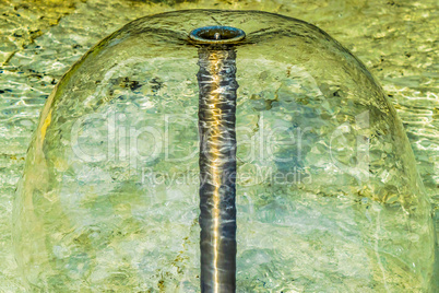 Fountain jet clear green water, closeup.