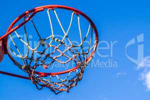 Basketball hoop outdoors, closeup, low angle view.