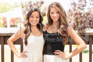 Two Mixed Race Girlfriends Pose for Portrait Outdoors