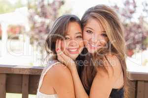 Two Mixed Race Girlfriends Pose for Portrait Outdoors