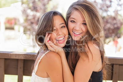 Two Mixed Race Girlfriends Pose for Portrait Outdoors