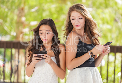 Two Expressive Mixed Race Girlfriends Using Their Smart Cell Pho