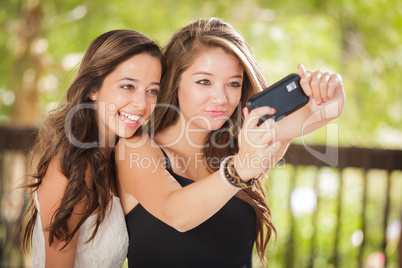 Two Attractive Mixed Race Girlfriends Using Their Smart Cell Pho