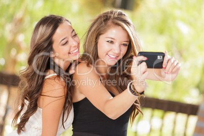 Two Attractive Mixed Race Girlfriends Using Their Smart Cell Pho