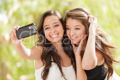 Two Attractive Mixed Race Girlfriends Using Their Smart Cell Pho