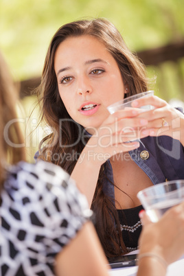 Expressive Young Adult Woman Having Drinks and Talking with Her