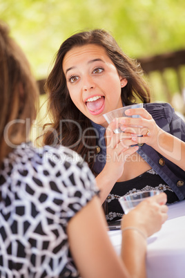 Expressive Young Adult Woman Having Drinks and Talking with Her