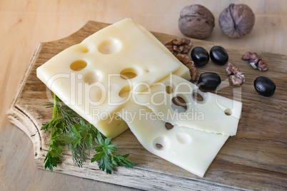 Cheese and walnuts on a cutting Board