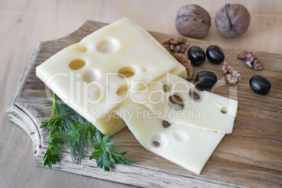 Cheese and walnuts on a cutting Board