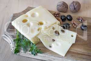 Cheese and walnuts on a cutting Board