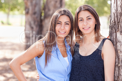 Two Beautiful Ethnic Twin Sisters Portrait Outdoors.