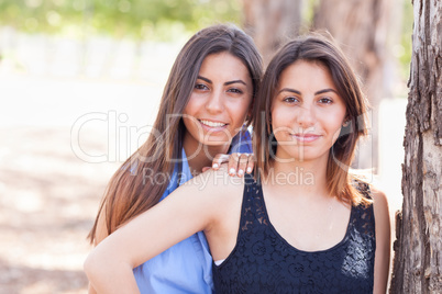 Two Beautiful Ethnic Twin Sisters Portrait Outdoors.
