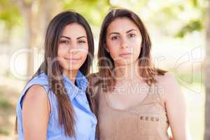 Two Beautiful Ethnic Twin Sisters Portrait Outdoors.