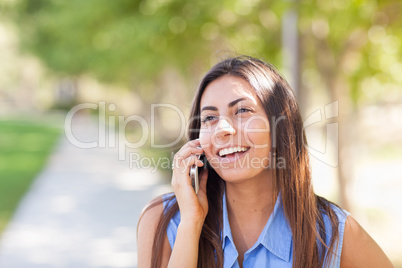 Beautiful Young Ethnic Woman Talking on Her Smartphone Outside.