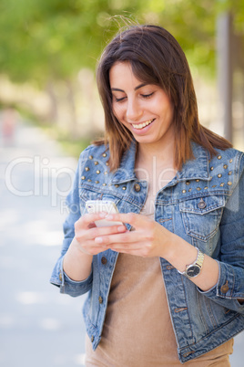 Beautiful Young Ethnic Woman Using Her Smartphone Outside.